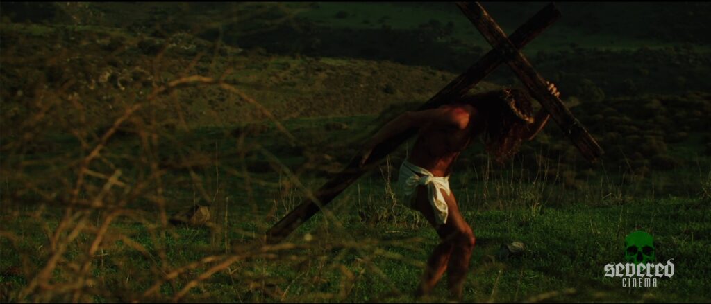 Jesus carrying the cross in Michael Moutsatos' movie Chameleon.