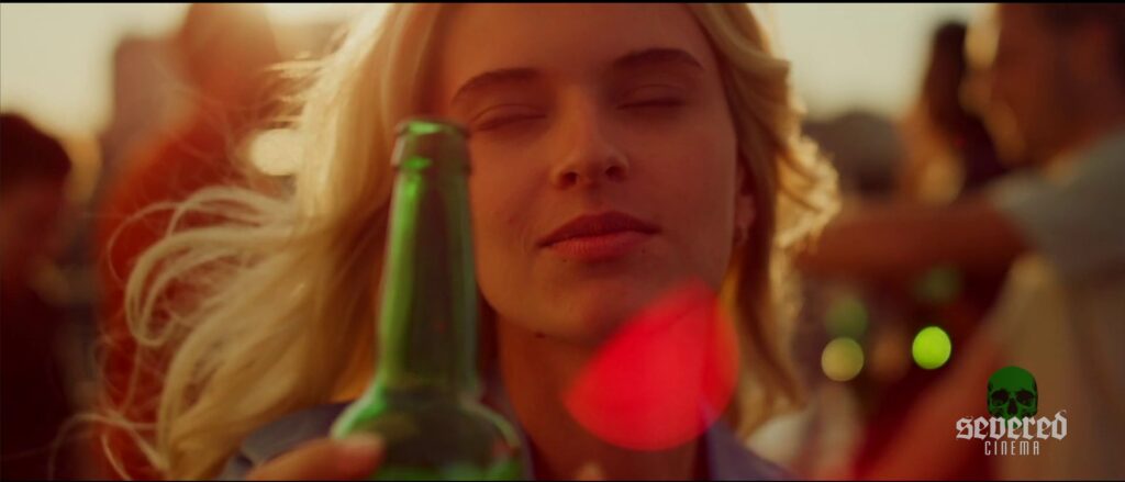 Woman drinking a beer in a green bottle in Michael Moutsatos' movie Chameleon
