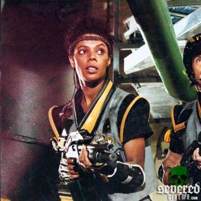 A young Geretta Geretta holding in gun.