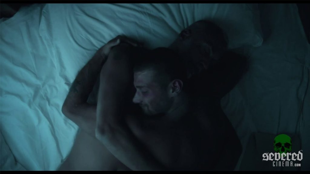 Movie screenshot of two men cuddling from the movie La perdición