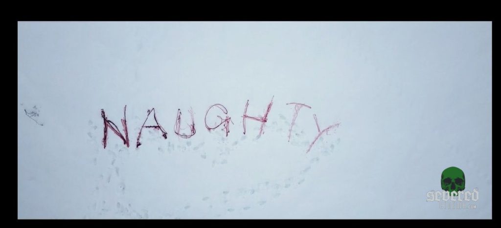 Naughty written on the ground in blood