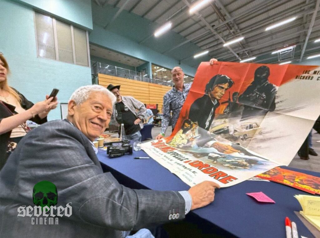 Enzo G. Castellari signing posters at Weird Worcester.